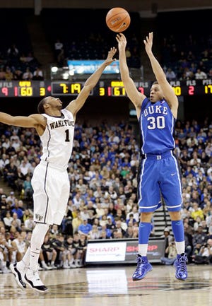 Duke's Seth Curry, right, shoots over Wake Forest's Madison Jones during the second half of Wednesday night's game.