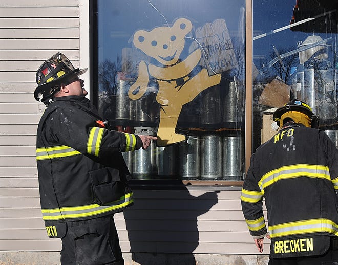 Firefighters work at the scene of a small fire at Strange Brew Beer and Wine Making on Boston Post Road East in Marlborough Thursday.