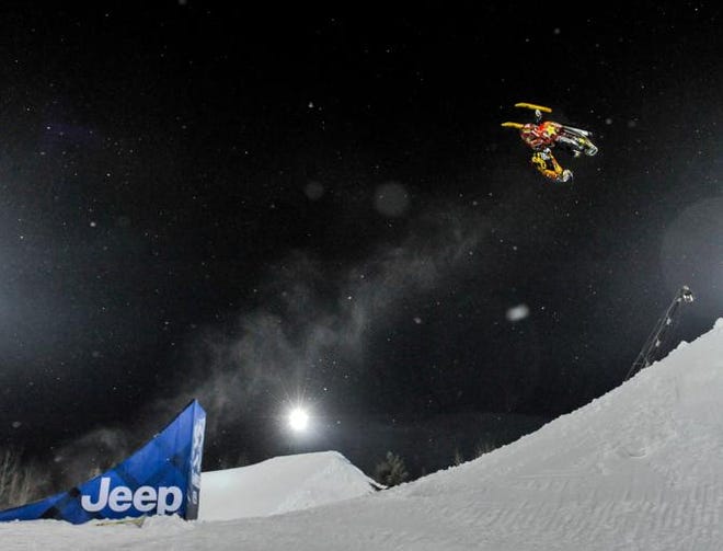 In this photo taken Jan. 24, 2013, Caleb Moore does a flip before he crashed during the ESPN Winter X Games snowmobile freestyle competition in Aspen, Colo. Moore died Thursday, Jan. 31, 2013, after suffering complications from injuries suffered during the snowmobile crash. He was 25.