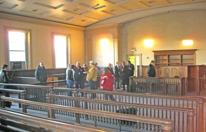 A group of about 20 residents tour the old courtroom at 15 Court St. that is set to be converted into a performing arts space/event hall during Thursday's Downtown Arts Space Tour.