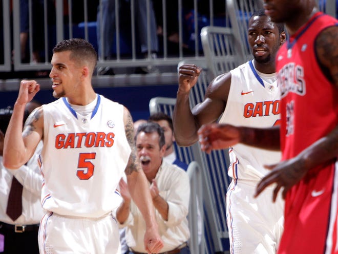 Florida guard Scottie Wilbekin, left, and center Patric Young pump their fists against Ole Miss during the first half on Saturday at the O'Connell Center. The Gators beat the Rebels for their 10th straight victory.