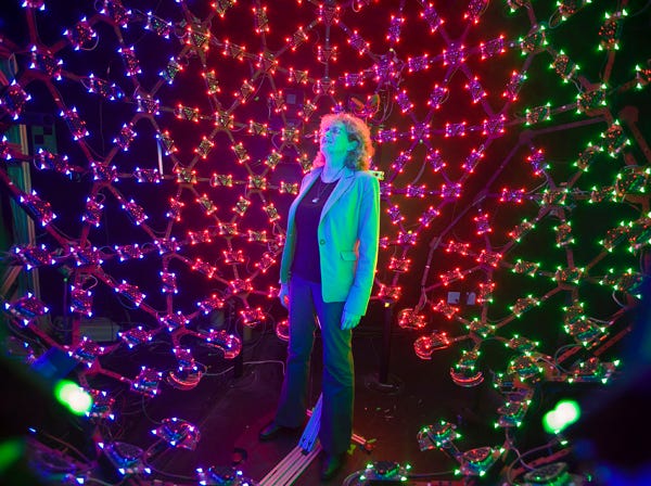 In this photo taken Tuesday, Jan. 29, 2013, University of Southern California Institute for Creative Technologies manager, Lori Weiss relaxes to music synchronized with color LEDs, inside the Lighting Stage X, the institute's latest LED-filled sphere used to help create realistic virtual characters in Playa Vista area of Los Angeles. The technology is used by the "Virtual Survivor Visualization," part of a collaboration with the Shoah Foundation to digitize aging Holocaust survivors to create three-dimensional holograms that would not only be able to tell their stories to future generations but to engage in dialogue with them. (AP Photo/Damian Dovarganes)