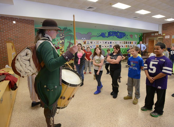 Dressed as a soldier of the 3rd New York Regiment of the Continental Army from 1777, William Sawyer, a living historian and park ranger with Fort Stanwix National Monument, raps military facing commands on his drum as 5th grade students at the N.A. Walbran Elementary School participate in a military facing exercise, Feb. 4, 2013, in Oriskany, N.Y.