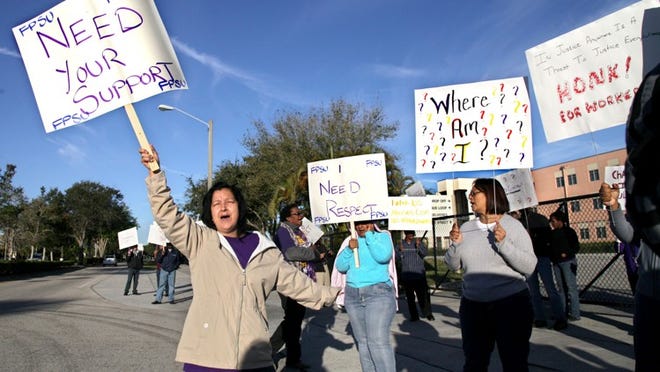 Carmine Martinez and other non instructional workers protest outside Palm Beach Gardens High School Monday, February 4, 2013. Saying school principals are not paying attention to them, they want more of a voice in their working conditions.