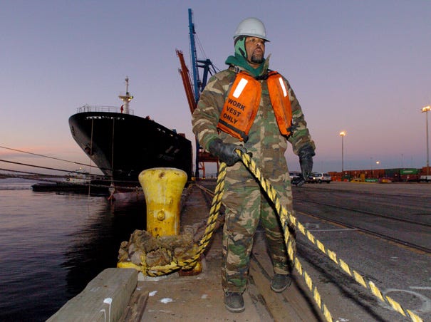 David Crummy helps secure a large container boat at the NC State Port at Wilmington while working with the International Longshoreman's Association in Feb. of 2007.