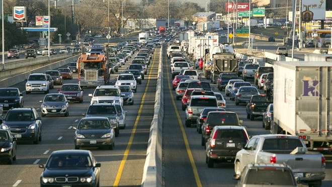 Commuters jam Interstate 35 north of Riverside Drive during rush hour in January. A new report indicates most of those drivers probably built considerable extra time into their trips because of unpredictable traffic.