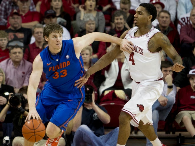 Florida's Erik Murphy dribbles around Arkansas' Coty Clarke during the first half in Fayetteville, Ark., on Tuesday. (AP Photo/Gareth Patterson)
