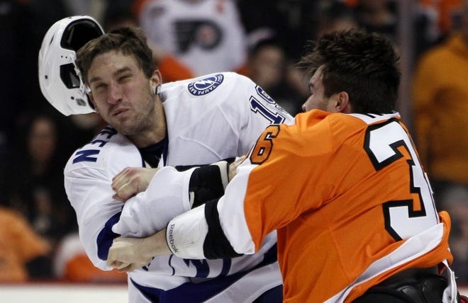 Philadelphia's Zac Rinaldo (right) lands a punch that knocks the helmet off Tampa Bay's B.J. Crombeen during a fight Tuesday.