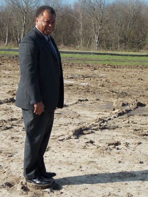 Donaldsonville Mayor Leroy Sullivan stands on a finished pile that was driven to support the foundation for the Gaubert Oil Company.