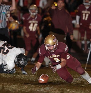 St Augustine's JP Bennett recovers a fumble by Atlantic Coast's Donnie Burton (22) during the fourth quarter of high school football action at St Augustine High School on Friday, Nov. 2, 2012. By GARY MCCULLOUGH, Special to The Record