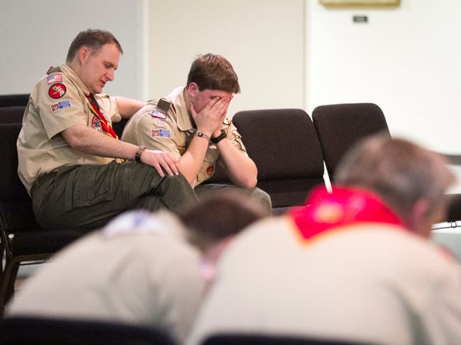 Scott Hines, scoutmaster for Troop 16 and his son Garrett, pray during a prayer vigil in the First Baptist Church Moores Lane in Texarkana, Texas on Tuesday, Feb. 5, 2013. Members of the troop, parents, and others prayed that the Boy Scouts of America would continue to keep their policy of excluding gay scouts and scoutmasters. The national executive board of the BSA began closed meetings on Monday to discus the policy.