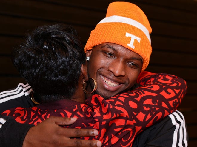 Gaffney defensive end Jaylen Miller hugs a well-wisher after signing with Tennessee during a ceremony at his high school on Wednesday.