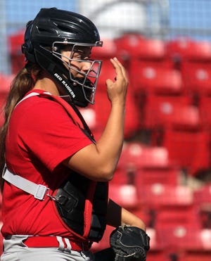 Texas Tech catcher Lexie Elkins signals to the field during practice Wednesday. Elkins is 17 years old and will rotate in as a starting catcher for the team. (Stephen Spillman)