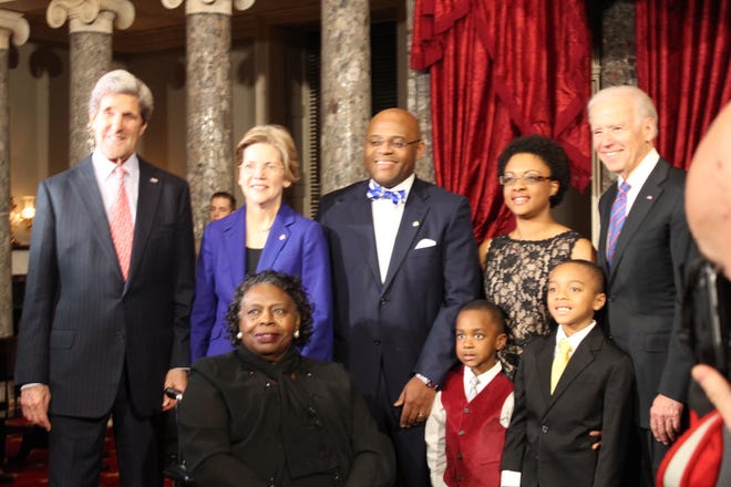 Massachusetts Sen. William “Mo” Cowan, of Stoughton with his wife Stacy, their sons Grant, 4, and Miles, 8, his mother, Cynthia Cowan, Secretary of State John Kerry, left, Sen. Elizabeth Warren and Vice President Joseph Biden after he was sworn in as interim U.S. senator on Thursday, Feb. 7, 2013.