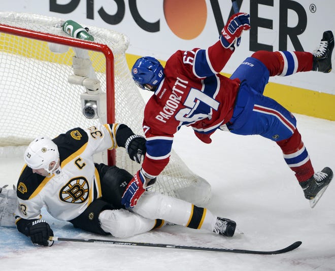Montreal Canadiens left wing Max Pacioretty (67) is upended by Boston Bruins defenseman Zdeno Chara (33) during the second period of their NHL hockey game, Wednesday, Feb. 6, 2013, in Montreal. ()