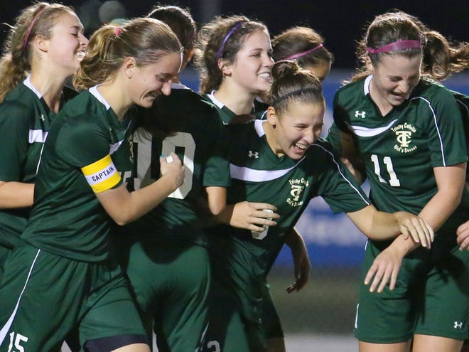 Trinity Catholic's Tabitha Tindell (3), center, celebrates with her teammates after her first goal during their 4-1 state championship win over Gulliver Prep during the FHSAA Class 2A soccer state final at Melbourne High School in Melbourne on Friday.