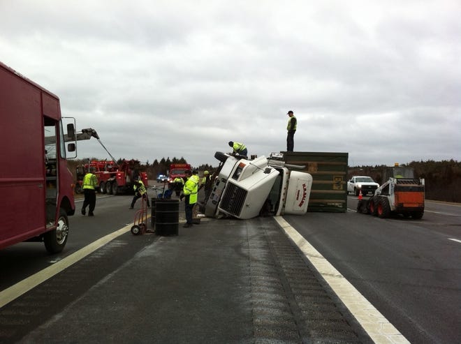 A truck from a paper company rolled over while traveling from Interstate 495 to Route 24 South in Raynham on Friday morning, Feb. 8, 2013. The crash jammed traffic for hours on both highways.