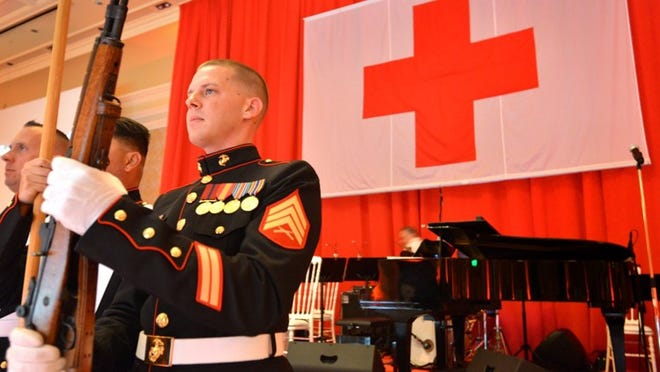 U.S. Marine Sgt. Tommy Reichling rehearses today for his role in the color guard at the 56th annual International Red Cross Ball.