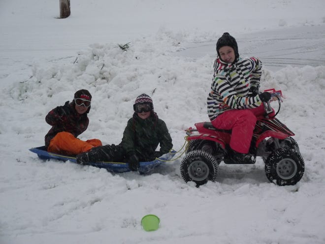 Caroline Francisco (12), Matthew Francisco (8) and Cameron White (9) have fun playing during the early part of the storm!