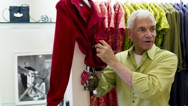 Alfred Fiandaca shows a red dress that Ann Romney wore during the 2012 presidential campaign.