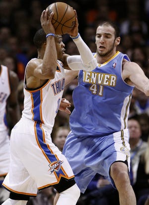 Oklahoma City Thunder guard Russell Westbrook goes to the basket as Denver Nuggets Kosta Koufos defends during the first half of an NBA basketball game in Oklahoma City, Wednesday, Jan. 16, 2013. Oklahoma City won 117-97.