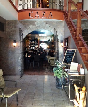 French inspiration fills the entrance to Caza's bar.