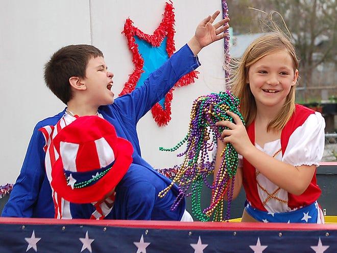 A float rider tosses beads to the crowd Sunday afternoon during the Montegut Children's Carnival Club parade.