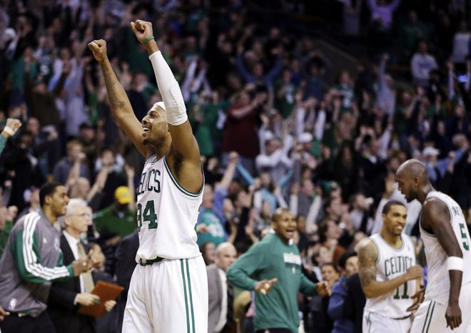 Boston Celtics forward Paul Pierce celebrates after they defeated the Denver Nuggets 118-114 in triple overtime in a basketball game in Boston on Sunday.