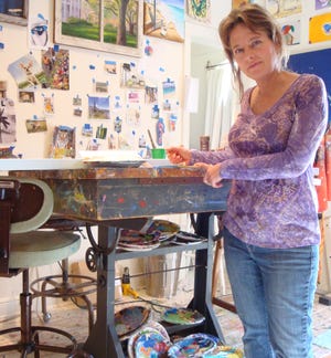 Cecilia in her studio working on a new painting.