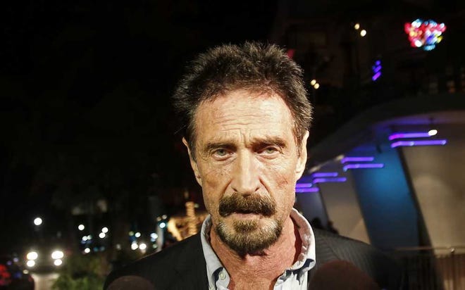 Anti-virus software founder John McAfee walks on Ocean Drive in the South Beach area of Miami Beach, Fla., Wednesday, Dec 12, 2012. McAfee arrived in the U.S. on Wednesday night after being deported from Guatemala, where he had sought refuge to evade police questioning in the killing of a man in neighboring Belize.(AP Photo/Alan Diaz)