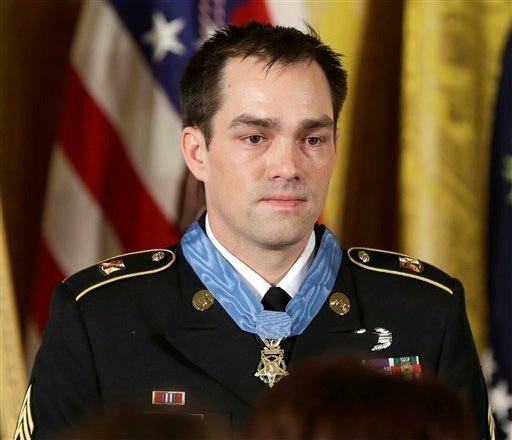Medal of Honor recipient, retired Staff Sgt. Clinton Romesha is seen on stage during the ceremony in the East Room of the White House in Washington, Monday, where President Barack Obama bestowed the medal. Romesha's leadership during a daylong attack by hundreds of fighters on Combat Outpost Keating in Afghanistan led to award.