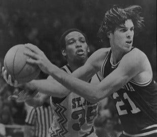 In this 1979 photo, Pennsylvania's Matthew White (21), right, grabs the ball in front of St. John's Reggie Carter (35) during the first half of an NCAA college basketball East Regional final in Greensboro, N.C. Matthew White was found stabbed in the neck around Feb. 11, in bed at his home in Philadelphia , police said, and was pronounced dead a short time later. An officer responding to the home for a report of a stabbing found White's wife, Maria Rey Garcia-Pellon, as she pulled into the driveway, authorities said. As she was being taken into custody, according to a police affidavit, she said, "I caught him looking at pornography, young girls. I love kids. I had to do it." (AP Photo/Michael O'Brien, File)
