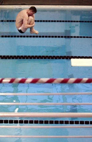 Beaver's Micah Ringer flips through the air as he dives during a swimming and diving meet at Beaver High School on Wednesday.