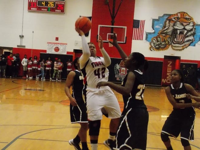 DHS’ Patrice West shoots a one-handed shot in the loss against St. James Friday night.