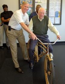 Parkdale Mills celebrated the 70th anniversary of board Chairman Duke Kimbrell's anniversary with the textile company on Jan. 30. Here, company CEO Andy Warlick presents Kimbrell with the same bicycle who used to ride to work in his early years with the company.