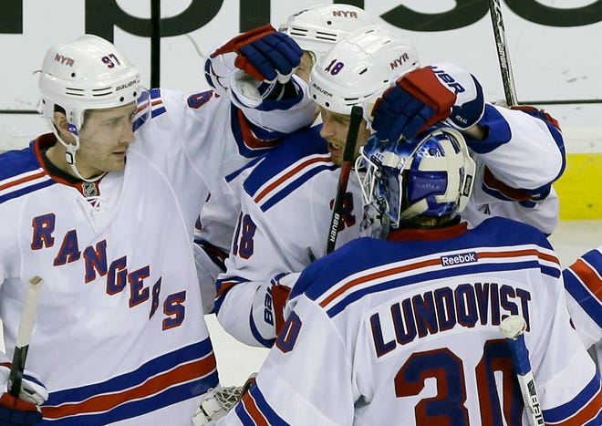 Rangers defensemen Matt Gilroy (left) and Marc Staal (18) celebrate with goalie Henrik Lundqvist after New York's 2-1 shootout win over the Bruins on Tuesday night.