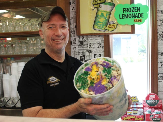 Bryan Nelson serves up some king cake ice cream at Scarlet Scoop Ice Cream Parlor in Houma.