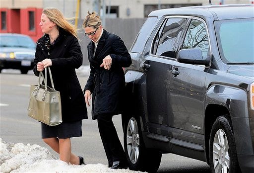 Rita Crundwell (right), the former comptroller of Dixon who pleaded guilty in November 2012 to wire fraud, admitting she stole nearly $54 million, arrives with her attorney, Kristin Carpenter, at the federal courthouse for her sentencing in Rockford on Thursday, Feb. 14, 2013.