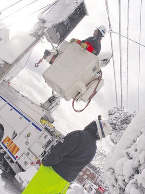 PHOTO BY BRENTON SNIZEK
RESTORING POWER: National Grid works on the city’s power lines 
following the blizzard.