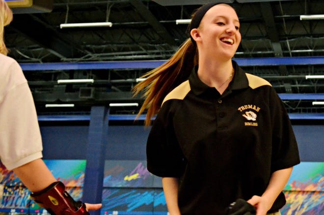 Harry S. Truman High School bowler Kelsey Hackbart is congratulated by other after she takes her shot during the Suburban One League bowling championships at Brunswick Zone in Feasterville Thursday, Feb. 14, 2013.