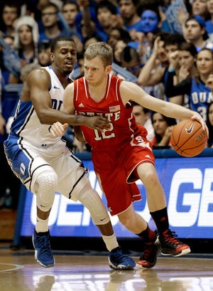 Associated Press N.C. State’s Tyler Lewis is defended by Duke’s Tyler Thornton during their game on Feb. 7 in Durham. N.C. State coach Mark Gottfried stated Lewis has earned the right for more playing time after filling in for Lorenzo Brown at point guard. Brown is expected to be back at full strength after missing two games due to an injury.