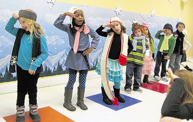 Dressed in warm clothing, kindergartners from TCELC perform to a large crowd with music and action to snowflake themed songs.