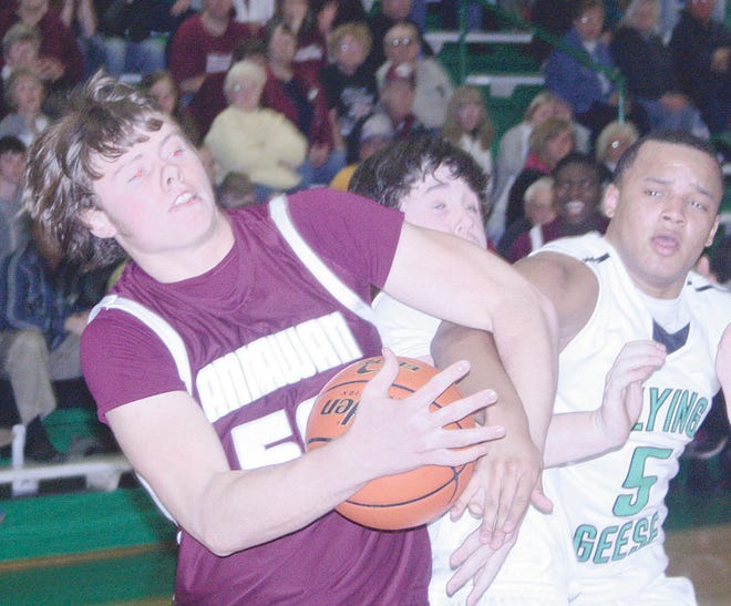 Donovan Kirkhove of Annawan, left, holds off Cody Phillips and Javonte Hollowell of Wethersfield in a battle for a rebound Friday night.