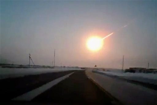 In this frame grab made from a video done with a dashboard camera, on a highway from Kostanai, Kazakhstan, to Chelyabinsk region, Russia, provided by Nasha Gazeta newspaper, on Friday, Feb. 15, 2013 a meteorite contrail is seen. A meteor streaked across the sky of Russia's Ural Mountains on Friday morning, causing sharp explosions and reportedly injuring around 100 people, including many hurt by broken glass.