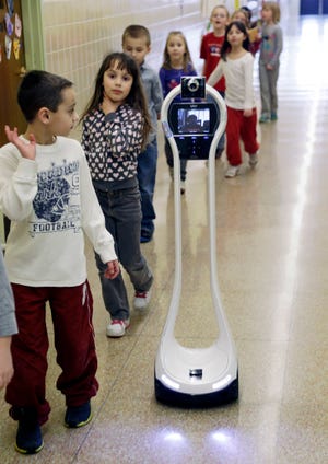 In this Thursday, Jan. 24, 2013 photo, Devon Carrow attends Winchester Elementary School from home while operating a robot in the school, in West Seneca N.Y. (AP Photo/David Duprey)