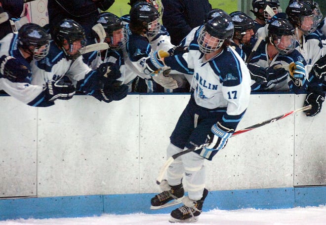 Franklin's Aiden Isberg celebrates a goal with the bench against Milford on Friday in Franklin.
