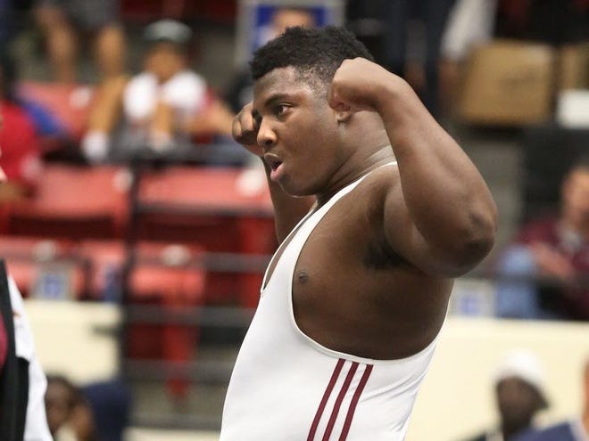 North Marion High School's Aaron Pringle celebrates his win over Wakulla's Christopher Griffin during the FHSAA Class 1A 285-pound Wrestling Championship at the Lakeland Center on Saturday.