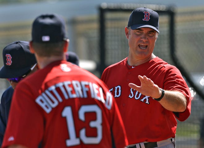 Boston Red Sox manager John Farrell, right, talks to third base coach Brian Butterfield during a spring training Wednesday, Feb. 13, 2013, in Fort Myers, Fla.