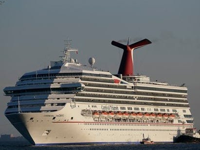 In this Feb. 14, 2013 file photo the cruise ship Carnival Triumph is towed into Mobile Bay near Dauphin Island, Ala., Thursday, Feb. 14, 2013. Want to know about a ship's track record for being clean? Want to assess how good or sanitary the food is? It's not that easy to find, in part because there's no one entity or country that oversees or regulates the industry with its fleet of ships that are like mini cities floating at sea. In the case of Carnival Cruise Lines, the owner of the Carnival Triumph that spent days in the Gulf of Mexico disabled after an engine fire, vacationers looking up information about the ship before boarding would have found mostly clean marks and few red flags. (AP Photo/Dave Martin)