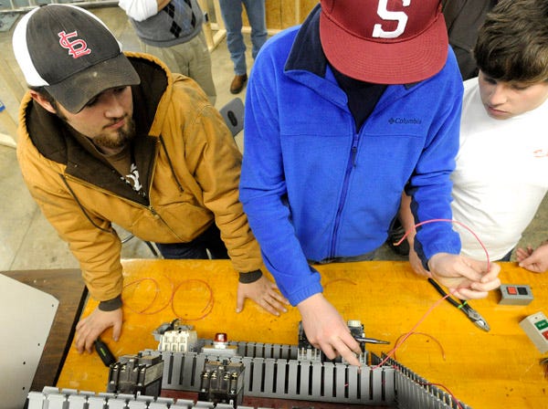 From left, Sardis High students Maverick Masters, Austin Beard and Cade Waters work on a group electrical exercise Wednesday at the Etowah County Technical School in Attalla.